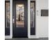 Elegant black front door with decorative glass sidelights and modern mailbox at 85 Grove Nw Ave, Concord, NC 28025