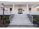Inviting front porch featuring white columns and railing, and a set of stairs leading to the entrance at 85 Grove Nw Ave, Concord, NC 28025