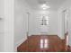 Bright hallway with hardwood floors, neutral walls, and views into other rooms, creating an open and inviting space at 85 Grove Nw Ave, Concord, NC 28025