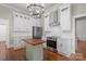 Well-lit kitchen with stainless steel appliances, a center island with a wooden top, and white cabinetry at 85 Grove Nw Ave, Concord, NC 28025