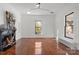 Inviting living room with hardwood floors, fireplace, and large windows providing natural light and a cozy atmosphere at 85 Grove Nw Ave, Concord, NC 28025