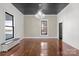 Bright living room with polished hardwood floors, contrasting ceiling, and large windows at 85 Grove Nw Ave, Concord, NC 28025