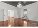 Spacious living room boasts hardwood floors, elegant chandelier, dark ceiling and natural light from a large window at 85 Grove Nw Ave, Concord, NC 28025