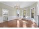 Inviting living room featuring hardwood floors, wainscoting, large windows, and an adjacent bathroom at 85 Grove Nw Ave, Concord, NC 28025