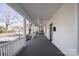Expansive front porch offers a relaxing outdoor space with classic white railings and a view of the neighborhood at 85 Grove Nw Ave, Concord, NC 28025