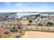 Aerial view of residential community, lake and surrounding area on sunny day at 9223 Robbins Preserve Rd, Cornelius, NC 28031