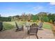 Serene backyard featuring a patio with Adirondack chairs and lush landscaping at 9223 Robbins Preserve Rd, Cornelius, NC 28031