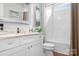 Bright bathroom featuring white cabinets, marble countertops, and shower and tub combination at 9223 Robbins Preserve Rd, Cornelius, NC 28031