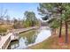 A serene lake view with a charming boardwalk perfect for leisurely strolls in the community at 9223 Robbins Preserve Rd, Cornelius, NC 28031