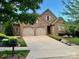 Charming two-story brick home with a well-manicured lawn, driveway, and a two-car garage at 9223 Robbins Preserve Rd, Cornelius, NC 28031