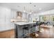Open kitchen with a large island, modern lighting, stainless steel appliances, and bar stool seating at 9223 Robbins Preserve Rd, Cornelius, NC 28031