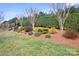Beautifully landscaped yard featuring colorful bushes and trees adding elegance and curb appeal to the property at 9223 Robbins Preserve Rd, Cornelius, NC 28031
