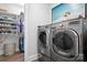 Convenient laundry room with modern washer and dryer units, closet, and storage solutions for organization at 9223 Robbins Preserve Rd, Cornelius, NC 28031