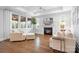 Cozy living room with a fireplace, hardwood floors, and bright, natural light at 9223 Robbins Preserve Rd, Cornelius, NC 28031
