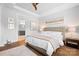 Serene main bedroom with tray ceilings, a ceiling fan, and an ensuite bathroom creating a peaceful retreat at 9223 Robbins Preserve Rd, Cornelius, NC 28031