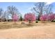 Community park featuring flowering trees and benches on a sunny day at 9223 Robbins Preserve Rd, Cornelius, NC 28031