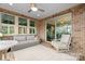 Covered patio with comfortable seating and brick flooring at 9223 Robbins Preserve Rd, Cornelius, NC 28031