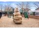 A fun playground in a fenced area featuring a climbing structure, slide, and padded ground at 9223 Robbins Preserve Rd, Cornelius, NC 28031