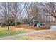 Playground nestled in a wooded area featuring a tree-themed climbing structure at 9223 Robbins Preserve Rd, Cornelius, NC 28031