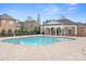 Community swimming pool with clear blue water, surrounded by brick pavers and a covered pavilion at 9223 Robbins Preserve Rd, Cornelius, NC 28031