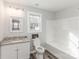 Bathroom with granite countertop vanity, toilet, and a tub shower combination at 1003 Harris St, Kannapolis, NC 28081