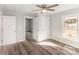 Bedroom with neutral paint, wood-look flooring, ceiling fan, and a connecting door at 1003 Harris St, Kannapolis, NC 28081