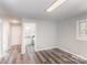 Empty room featuring hardwood floors, neutral walls, and connections to nearby rooms at 1003 Harris St, Kannapolis, NC 28081