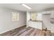 Bright kitchen with white cabinetry, granite countertops, and wood-look flooring at 1003 Harris St, Kannapolis, NC 28081