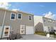 Exterior view of newly constructed townhomes showing garage, front door, and driveway at 1211 Pine St # A, Mooresville, NC 28115