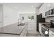 Modern kitchen features stainless appliances, granite counters and a view to the living area at 1211 Pine St # A, Mooresville, NC 28115