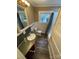 Neutral bathroom featuring updated floors, a wood vanity, and a shower with a light grey curtain at 122 E Hargrave St # 50, Wadesboro, NC 28170