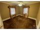 Bedroom with a ceiling fan, brown carpet, and a double window covered with tan curtains at 122 E Hargrave St # 50, Wadesboro, NC 28170