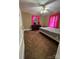 Bedroom with a ceiling fan, brown carpet, and a double window covered with pink curtains at 122 E Hargrave St # 50, Wadesboro, NC 28170