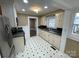Clean kitchen featuring white cabinets, stainless steel appliances, and vinyl floors at 122 E Hargrave St # 50, Wadesboro, NC 28170