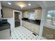Traditional kitchen with black and white tile flooring, window over sink, and views to the next room at 122 E Hargrave St # 50, Wadesboro, NC 28170