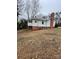 Rear exterior view showing the access stairs, foundation, and small back porch at 122 E Hargrave St # 50, Wadesboro, NC 28170