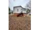 Rear exterior showing the access stairs, foundation, and small back porch at 122 E Hargrave St # 50, Wadesboro, NC 28170