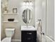 Clean bathroom featuring a vanity, shelving, and an oval mirror at 16404 Mckee Ridge Dr, Charlotte, NC 28278