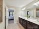 Well-lit bathroom with a double vanity, expansive mirror, and neutral tones, providing a clean and functional space at 16404 Mckee Ridge Dr, Charlotte, NC 28278