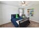Bright bedroom showcasing a built-in bookcase, a comfortable chair, and ample natural light at 16404 Mckee Ridge Dr, Charlotte, NC 28278