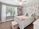 Charming bedroom featuring a white-painted bed, unique wallpaper, and plentiful natural light at 16404 Mckee Ridge Dr, Charlotte, NC 28278