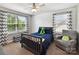 Charming bedroom featuring a ceiling fan, plush bedding, and a cozy armchair for a relaxing retreat at 16404 Mckee Ridge Dr, Charlotte, NC 28278