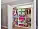 Organized closet with shelves, hanging rods, and colorful items for efficient storage at 16404 Mckee Ridge Dr, Charlotte, NC 28278