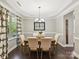 Formal dining room with stylish lighting, dark wood floors, and large windows at 16404 Mckee Ridge Dr, Charlotte, NC 28278
