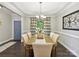 Dining room with wood table, upholstered chairs, overhead light fixture, and light gray walls at 16404 Mckee Ridge Dr, Charlotte, NC 28278