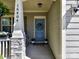 Inviting front door with blue wreath, flanked by plants, number 16404, and a welcoming 'HUGS' doormat at 16404 Mckee Ridge Dr, Charlotte, NC 28278