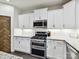 Gourmet kitchen featuring stainless steel appliances, white cabinets, and granite countertops for a sleek look at 16404 Mckee Ridge Dr, Charlotte, NC 28278