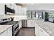 Bright kitchen featuring granite countertops, stainless steel appliances, and white cabinetry at 16404 Mckee Ridge Dr, Charlotte, NC 28278