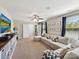 Inviting living room with a large sectional sofa, a TV, and ample natural light at 16404 Mckee Ridge Dr, Charlotte, NC 28278
