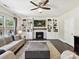 Comfortable living room showcasing a fireplace, custom shelving, and natural light at 16404 Mckee Ridge Dr, Charlotte, NC 28278